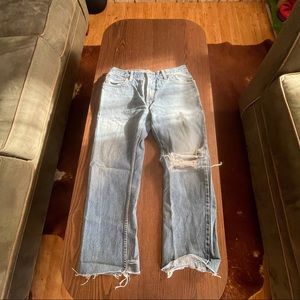 Ripped knee blue jeans